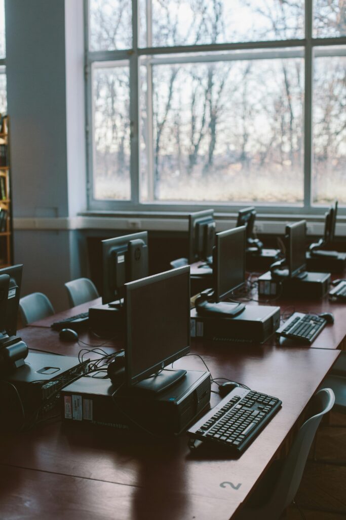 pexels photo 3747481 3747481 Spacious computer lab with rows of monitors and keyboards in a sunlit room.